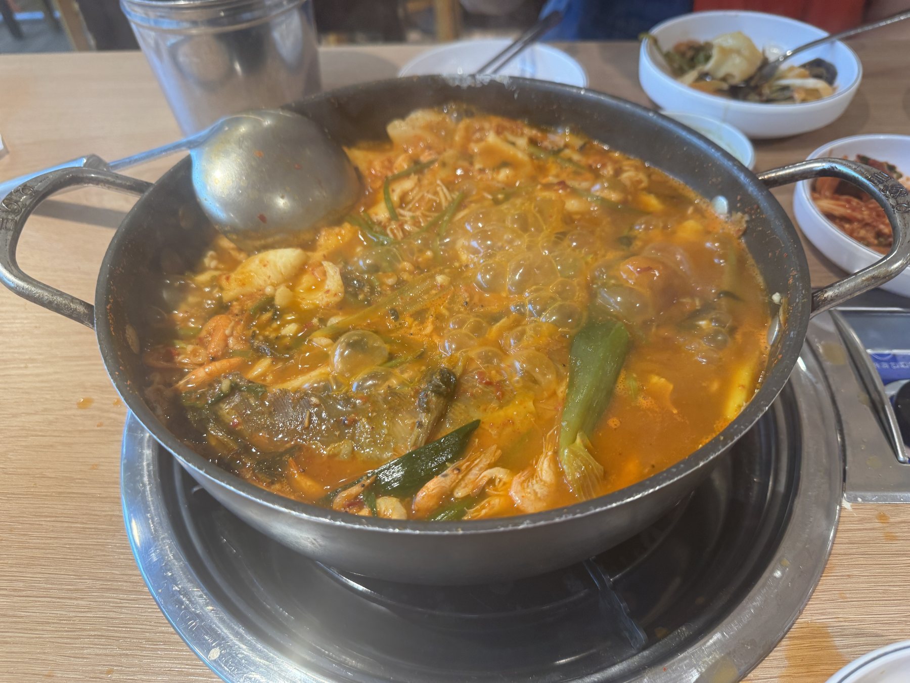 Spicy catfish stew at a full boil